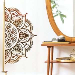 Detail of bohemian dark brown mandala wall decal on a white bedroom background