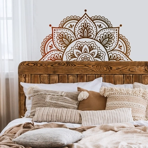 Brown mandala wall sticker featuring symmetrical bohemian floral patterns above a bed headboard
