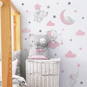 Detail view of cartoon elephant wall stickers with clouds and stars in a cozy nursery room