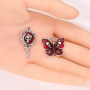 Gothic skull pendants in mirror and butterfly shapes with red enamel on silver alloy