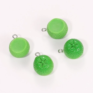 Detailed macro view of four green resin fruit charms with fine textures and silver loops
