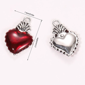 Detail showing dimensions of red enamel heart charms with flame motif, 1.4cm by 2.1cm size