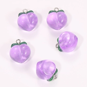Detailed macro view of purple resin peach charms with sparkling glitter and silver ring