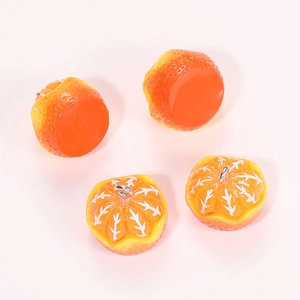 Macro shot of realistic resin orange charms with detailed texture and silver metal rings