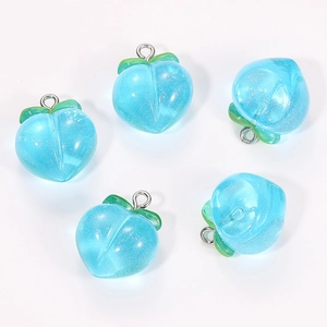 Detailed macro view of five translucent blue resin peach charms with sparkling glitter