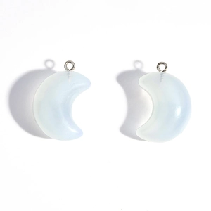 Detail shot of translucent opal white acrylic crescent moon pendants for DIY jewelry