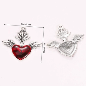 Macro detail of retro gothic wing heart pendant showing front, back and 3.3cm size dimensions