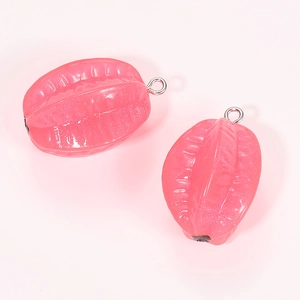 Macro view of two pink carambola resin pendants with silver metal loops and glitter