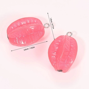 Detail view of pink starfruit resin pendants with silver metal loops for DIY crafting
