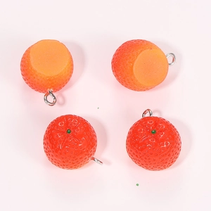 Macro detail of four resin strawberry charms showing realistic texture and metal rings