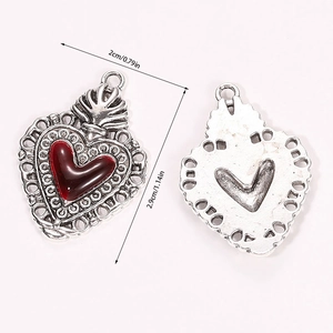 Detailed view of vintage gothic silver heart pendant with red resin and dimensions
