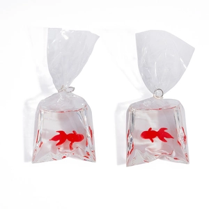 Detailed close-up of a creative resin goldfish in water bag pendant earring with a silver hook