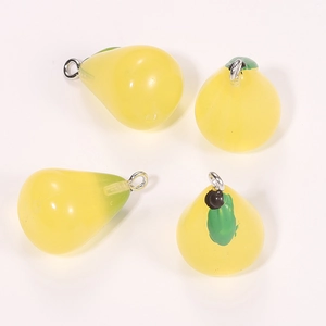Detail of four yellow resin pear charms with green leaves and silver rings for DIY crafts