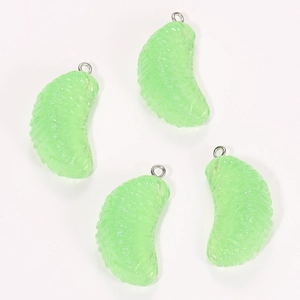 Close-up of four translucent green resin citrus slice charms with silver metal rings