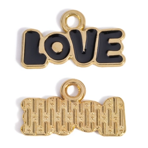 Macro detail of LOVE pendant showing gold metal plating and black enamel on both sides