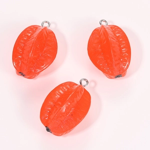 Three realistic resin starfruit pendants in bright orange-red with silver metal rings