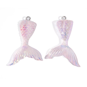 Detailed macro view of iridescent pink resin mermaid tail charms with scaly texture