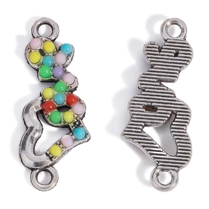 Macro detail of deer head jewelry connectors with colorful resin inlay and textured back