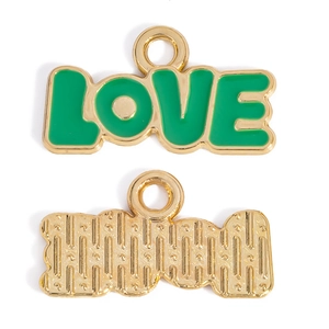 Detail of green enamel LOVE pendant with gold trim showing front and back texture