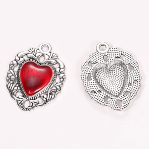 Vintage silver heart pendant with red enamel inlay and intricate hollow filigree details