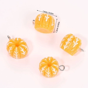 Macro shot of 4 resin pumpkin pendants with white veins and silver loops for DIY