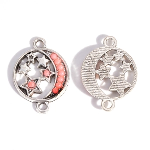Detail of vintage silver moon star connector pendants with pink beads and hollow stars