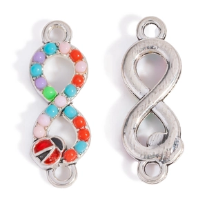 Macro view of infinity connector with colorful resin beads and ladybug enamel detail