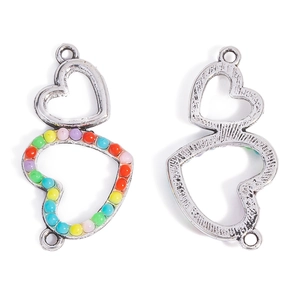 Macro detail of heart-shaped multi-color beaded alloy charms showing front and back view