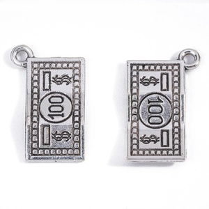 Macro detail of silver dollar sign and 100 bill rectangular alloy jewelry pendants