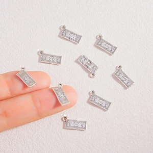 Mini silver dollar bill currency pendants for DIY jewelry making with dollar sign engraving