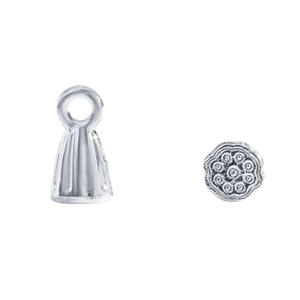 Detailed macro view of vintage silver lotus charms and bell-shaped tassel caps for DIY jewelry