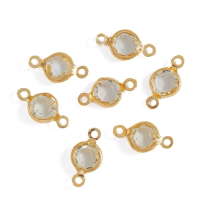 Detailed macro view of seven round faceted glass connectors with gold double loop edges