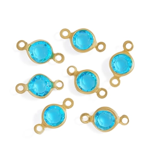 Macro detail of seven light blue faceted glass charms with gold plated copper connectors