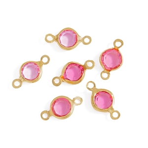 Detailed view of pink faceted glass connector charms with gold plated settings for DIY jewelry