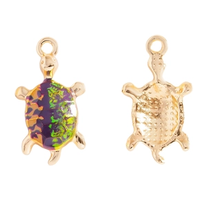 Front and back detail of gold alloy sea turtle pendants with purple and green enamel