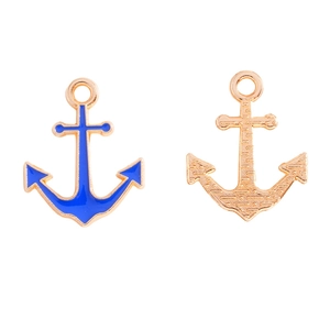 Macro shot of gold alloy nautical anchor pendants with navy blue enamel inlay for DIY jewelry