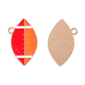 Detail of red and orange enamel rugby ball charm with gold textured back for DIY jewelry