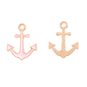 Macro detail of gold-plated anchor pendants with pink enamel and mesh back texture