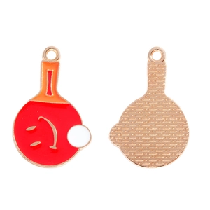 Close-up of enamel ping pong paddle charms with smiling faces and metallic textures