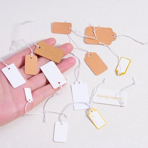 Assorted paper gift tags in brown and white with cotton string for jewelry packaging
