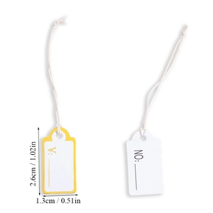 Close-up of small white paper jewelry price tags with cotton string, 2.6cm x 1.3cm