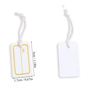 Detail view of small white paper gift tags with yellow border and hanging string