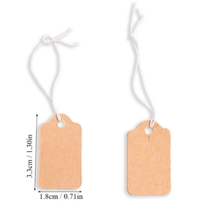 Detailed view of brown kraft paper tags with white strings and precise size measurements