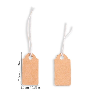 Detail of small kraft paper tags with white strings measuring 2.6cm by 1.3cm
