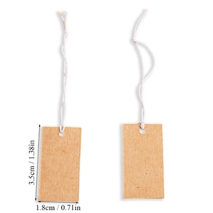 Detailed view of brown kraft paper gift tags with white string and dimensions listed