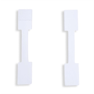 Close-up of barbell shaped white adhesive jewelry price tags for rings and necklaces