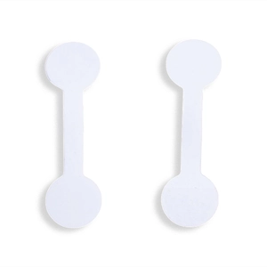 Close-up of blank white barbell jewelry labels for ring and necklace pricing tags
