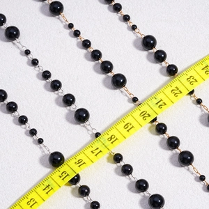 DIY black pearl link chain for jewelry making with alternating bead sizes and measuring tape