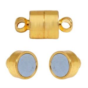 Close-up of golden cylindrical magnetic jewelry clasps for DIY necklaces and bracelets