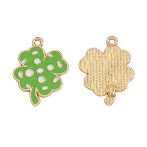 Detail of green four-leaf clover charms with white dots and golden metal back